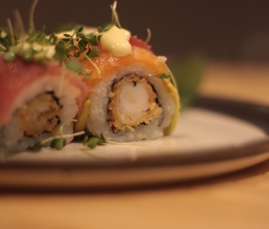 A Rainbow Roll with prawn, salmon, tuna, and avocado.