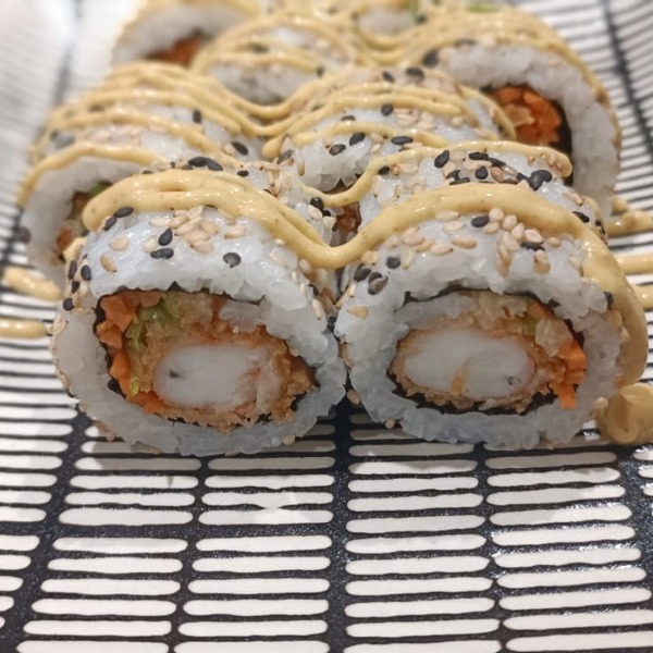 A plate featuring the Prawn Katsu roll, a weekly premium uramaki with prawn katsu, mayo, carrots, ginger, and sesame seedss.